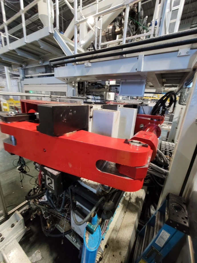 Replacement steel arm installed on a blow molding machine