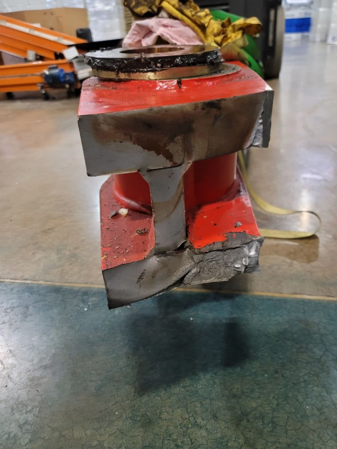 Broken steel arm removed from a blow molding machine